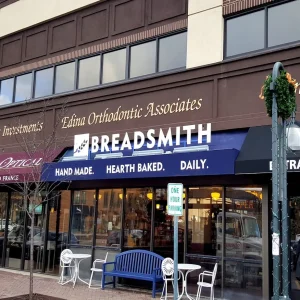 Blue awning with white vinyl lettering and white dimensional letters at a bakery