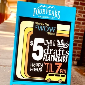 a sidewalk sign for a pub that promotes their specials