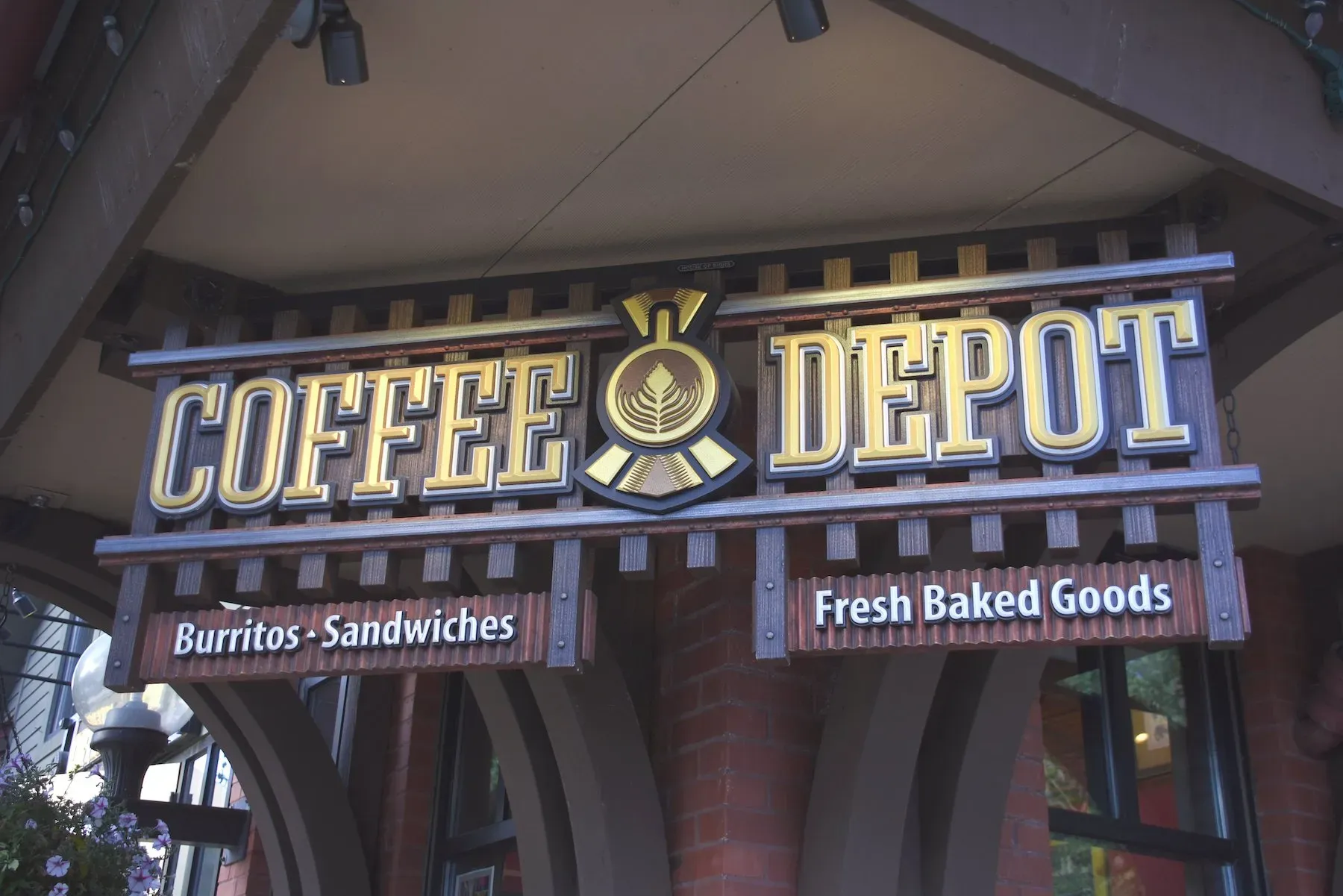 An elaborately constructed sign that says coffee depot in 3d lettering, with a logo between the two words.