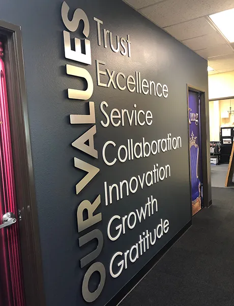 An office wall that has 3D letter signage on it.