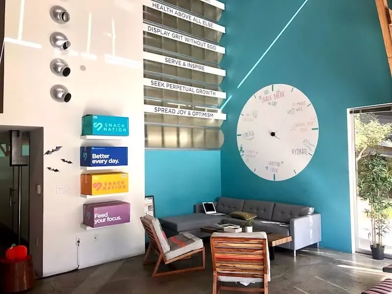 The lobby of an office with various motivational signs on the wall.